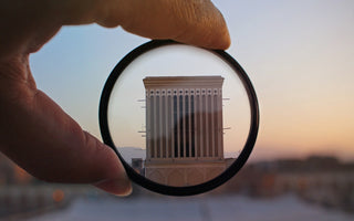 A ND filter pointed against a white building at hand