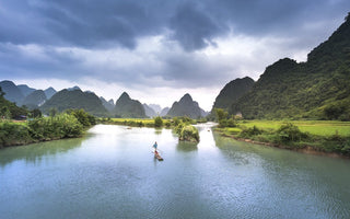 person on the canoe drifting on a big river shot by a camera trigger