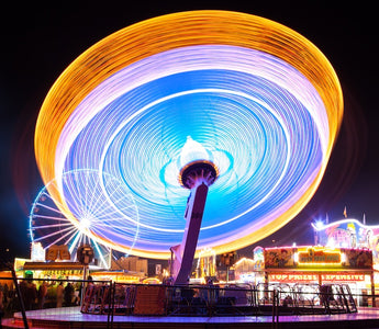 a colorful and moving ferris wheel shot at long exposure