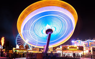 a colorful and moving ferris wheel shot at long exposure