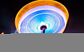 a colorful and moving ferris wheel shot at long exposure