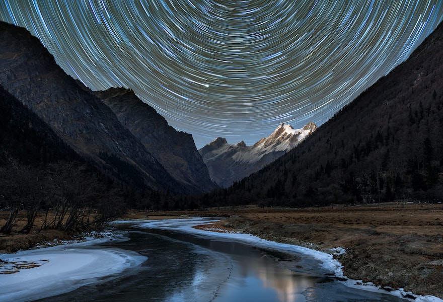 star trails above mountains