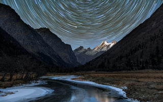 star trails above mountains