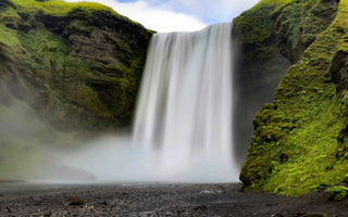 A wide waterfall pouring down the hill